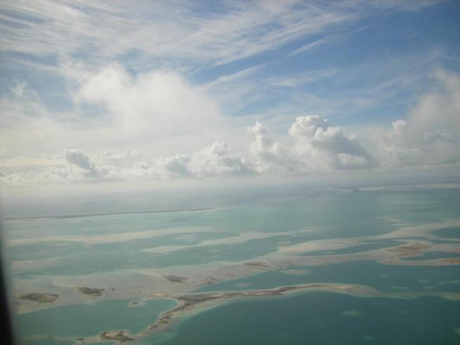 Flying over the largest coral atoll in the world and looking towards the lagoon opening on the wouthwestern side.